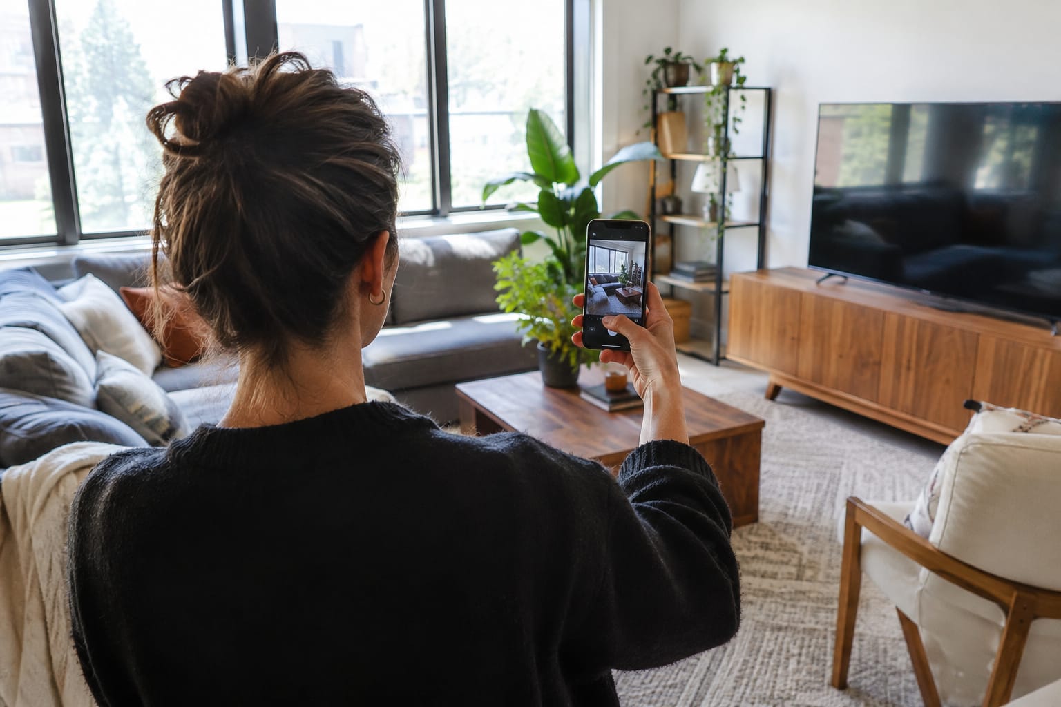 Customer recording a smartphone walkthrough of living room furniture for a remote estimate